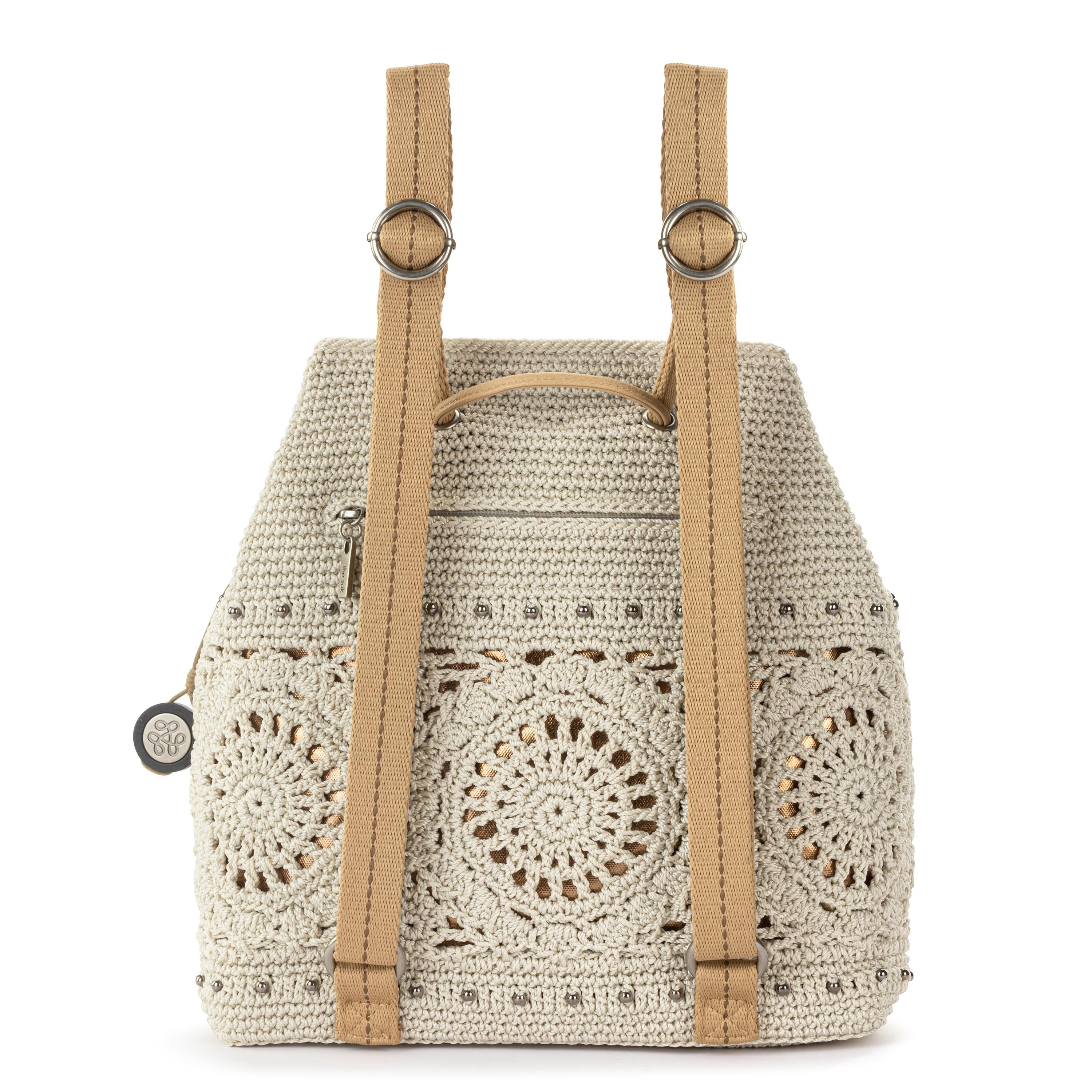 brown faux leather backpack with ivory floral crochet overlay The Sak Sayulita Backpack - Hand Crochet