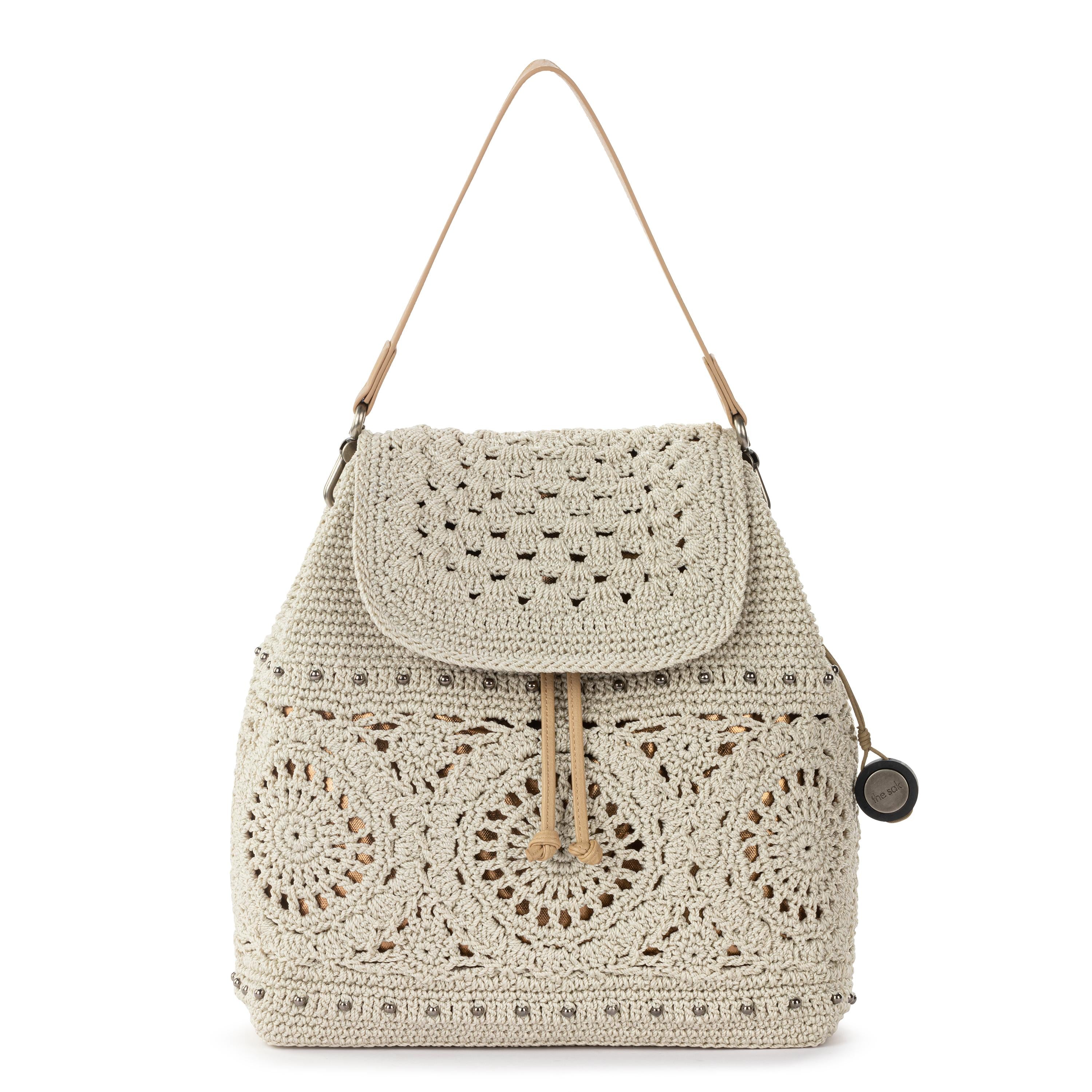brown faux leather backpack with ivory floral crochet overlay The Sak Sayulita Backpack - Hand Crochet