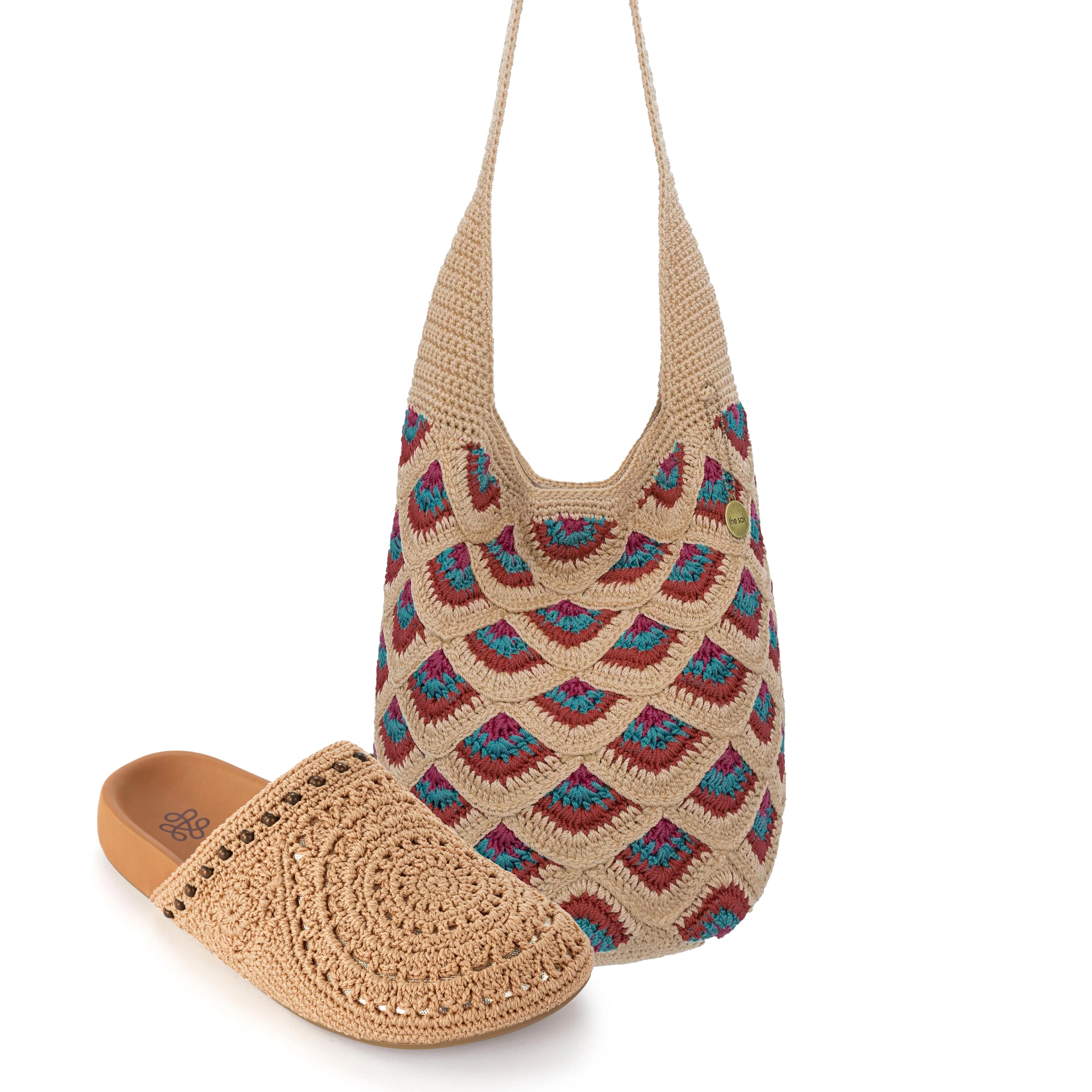 Tan crochet hobo bag with blue and burgundy geometric pattern and matching tan crochet clog with spiral design.