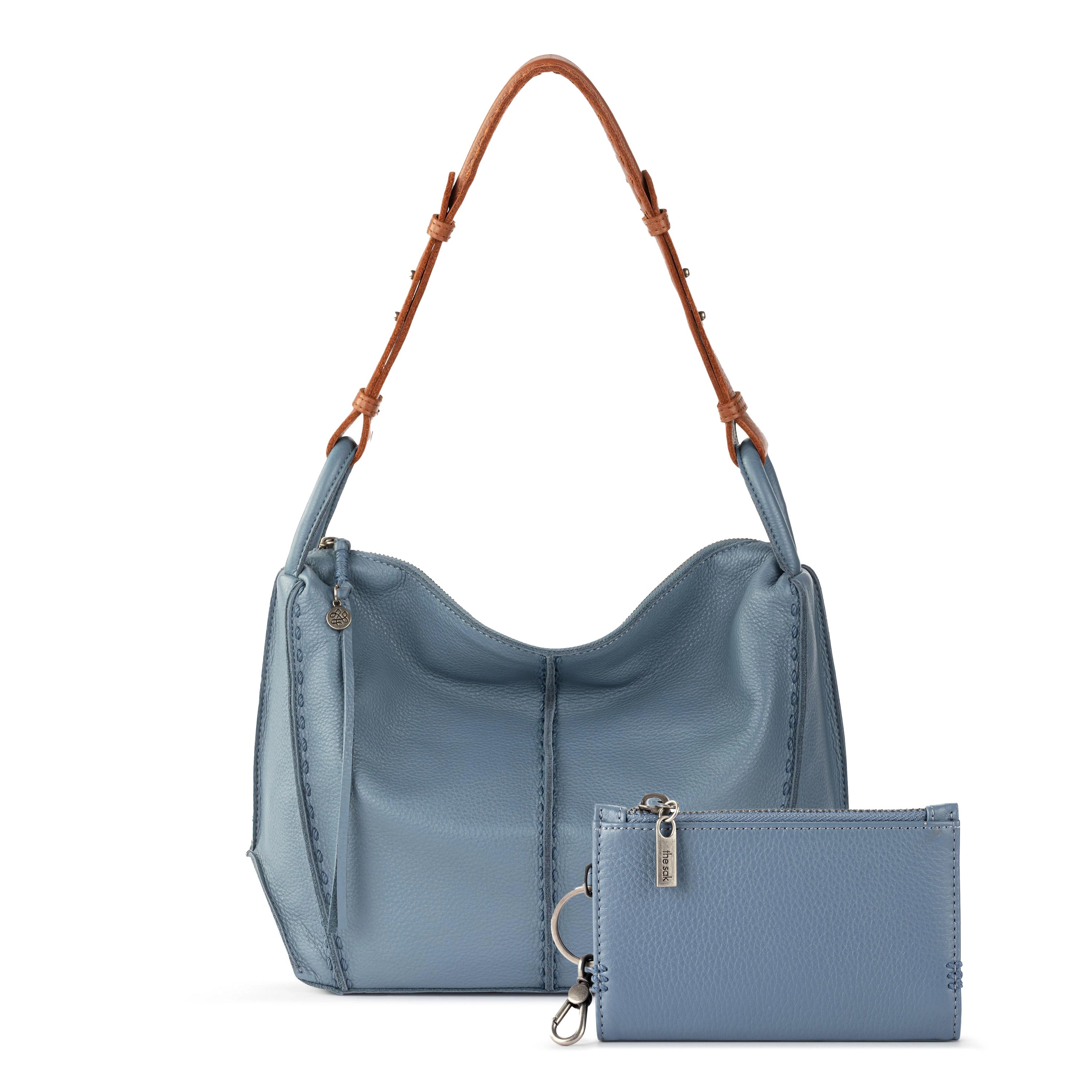Blue leather hobo bag with brown handles and matching blue wallet with silver hardware.